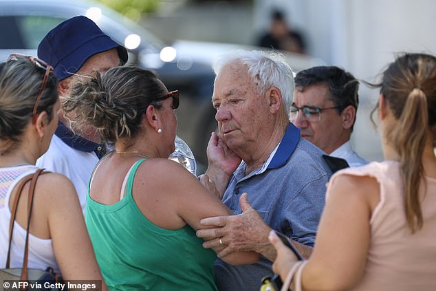 The grandfather of Diogo Jota and Andre Silva is comforted outside the funeral chapel