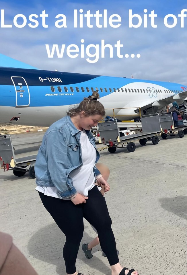 Woman walking on an airport tarmac with a child, in front of an airplane.