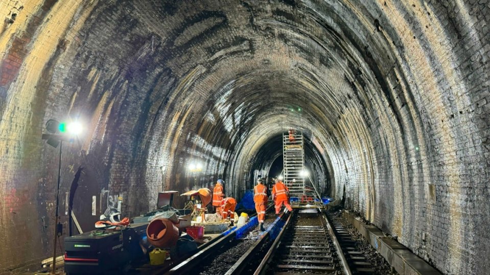 Workers repairing a railway tunnel.