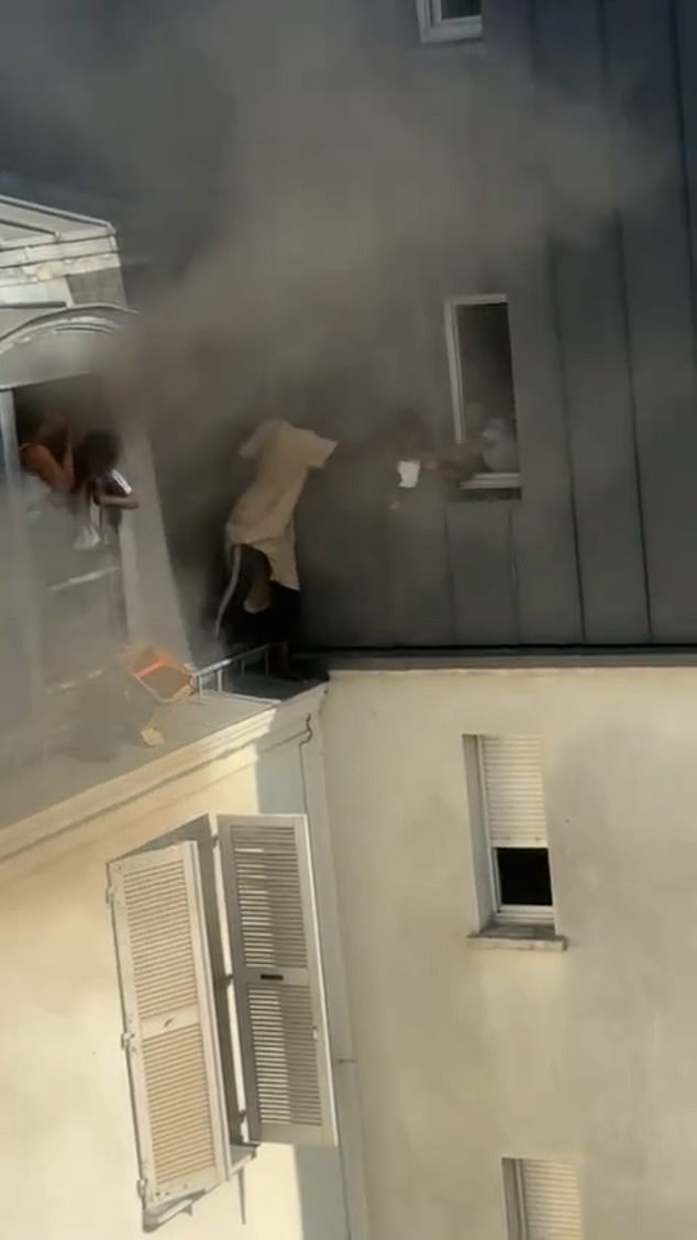 Fousseynou Cissé, 39, said he 'didn't think twice' about the danger as he stood on a ledge outside window to help those inside