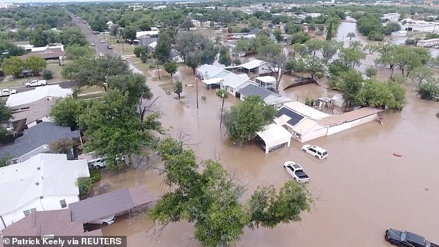 The final death toll is expected to rise as dozens remain unaccounted for after the unexpected flood (Pictured: A drone view of flooded houses along the Guadalupe River)