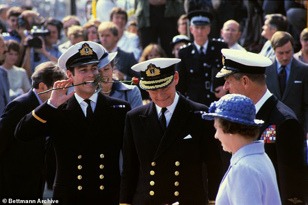 Prince Andrew holds a rose in his mouth as he is greeted by his mother and father, Queen Elizabeth and Prince Philip (right), on his return from the Falklands