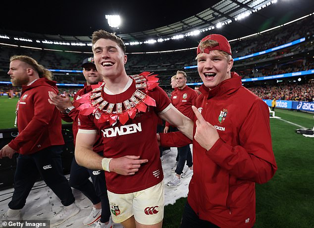 Many of the Lions players wore elaborate garlands around their neck made up of chocolate bars festooned with ribbons, which had been presented to them by Sione Tuipulotu's family