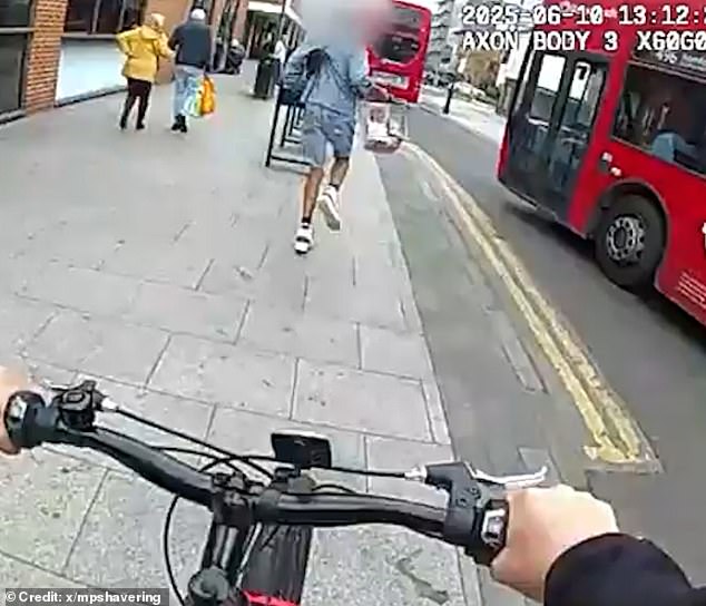 Wearing a checked blue shirt with denim shorts and white trainers, he then appears to notice he is being tailed by one officer and begins running away