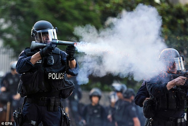 Los Angeles police fire tear gas at activists protesting against immigration raids in the city last month