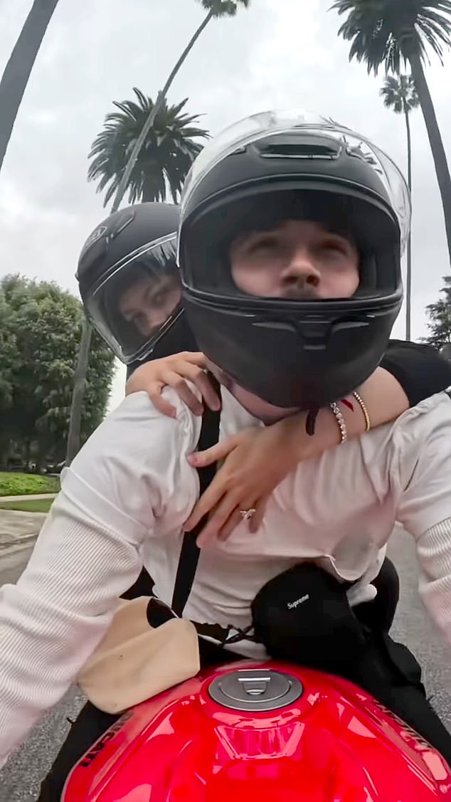 Brooklyn driving a very fancy red motorbike through empty streets while Nicola rides pillion, to the tune of Lana Del Rey’s National Anthem (‘do you think you’ll buy me lots of diamonds?’). Caption on Instagram reads: ‘Me and you forever baby’