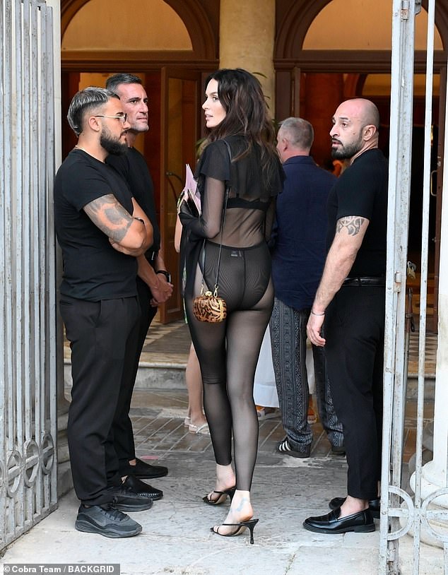 Her sheer black underwear could be seen underneath as it sat high on her hips