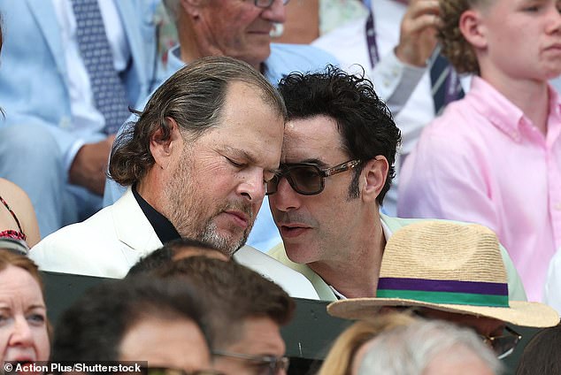 English actor Sacha (R) was seen chatting to a guest in the stands during the Gentlemen's Single Final at the All England Lawn Tennis and Croquet Club