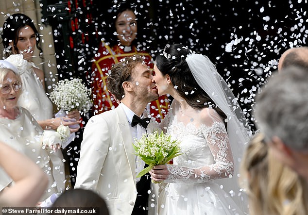 Earlier in the day, the newlyweds shared a passionate kiss as white confetti fell on them after the romantic ceremony