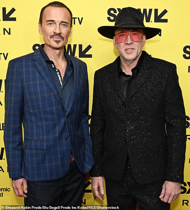 Julian McMahon (left) has been fondly remembered by Nicolas Cage, his co-star in the new film The Surfer, which they are pictured promoting at SXSW this March