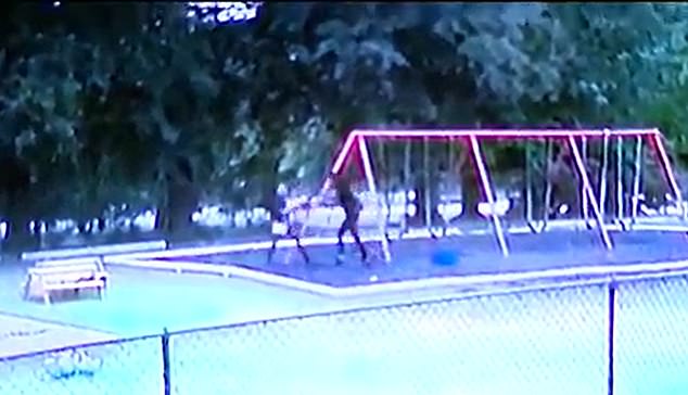Nash, Montgomery and their daughter Khloe, then exited the daycare through a rear door and headed into a wooded area behind the facility. Pictured: CCTV footage shows Taco Nash forcing Mi'ckeya Montgomery through a playground and into the direction of a wooded area behind the childcare facility