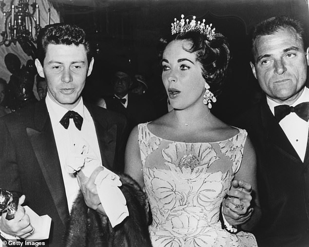 The stunning diamond earrings were given to actress Elizabeth Taylor by her husband Mike Todd (r) in 1957, shortly before his death in 1958; Pictured in Los Angeles in February 1958