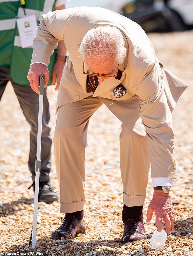 The monarch, dressed in a smart light brown summer suit, was seen collecting rubbish along the shoreline as part of an event organised by local environmental group Deal With It