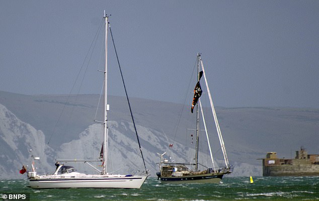 A kite surfer has died following a 'freak accident' where he was reportedly blown out of the water in high winds and thrown into the side of a moored yacht
