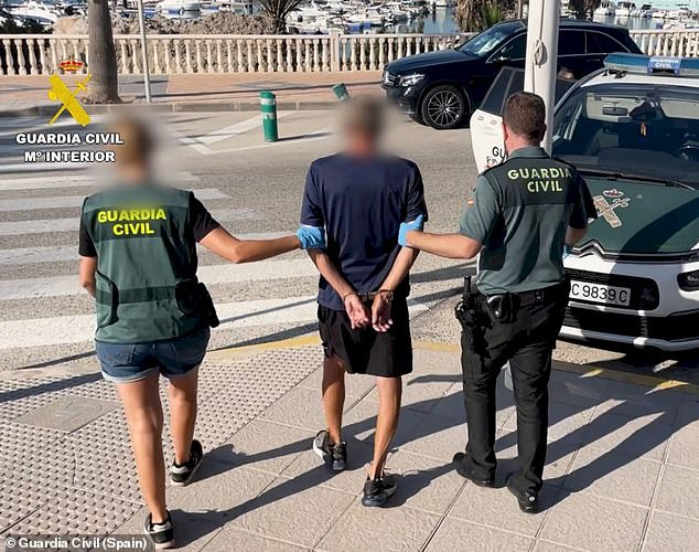 A suspect is arrested by two members of the Guardia Civil for the attempted murder of Dan McMeekin