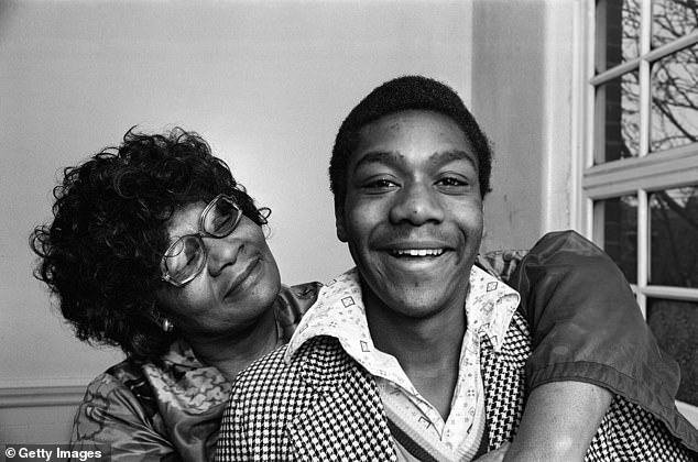 Lenny Henry, 66, has revealed he used humour as his 'shield' against racist bullies during his childhood (pictured with his mother Winifred in 1975)