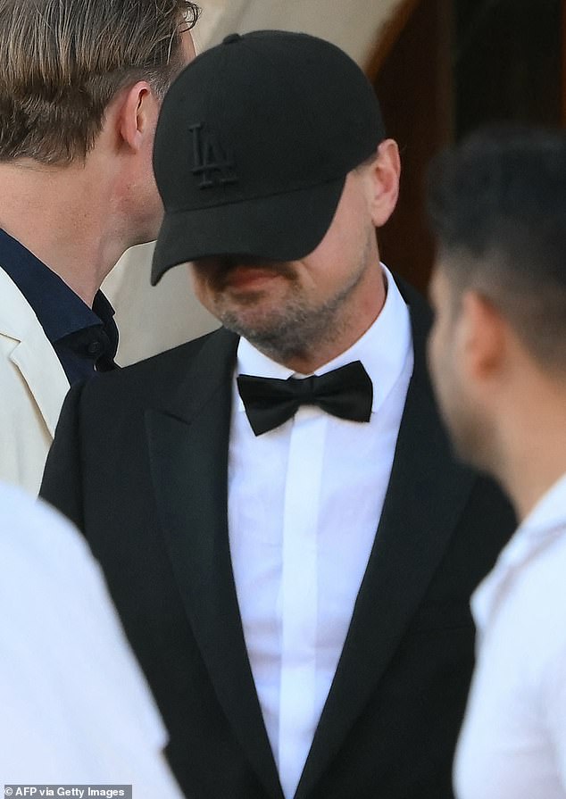 The star was brutally mocked online for seemingly trying to 'hide' from cameras during the three-day wedding by wearing a hat low down over his eyes and nose; seen on June 27