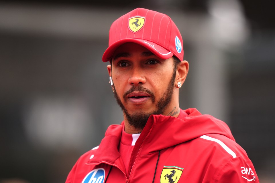 Lewis Hamilton in a Ferrari jacket and cap.