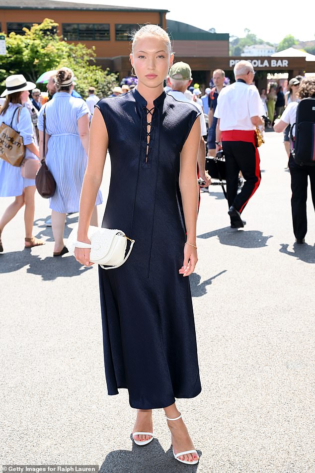 Lila Moss cut a sophisticated figure in a navy dress as she arrived at the All England Lawn Tennis and Croquet Club on Sunday for day 14 of Wimbledon