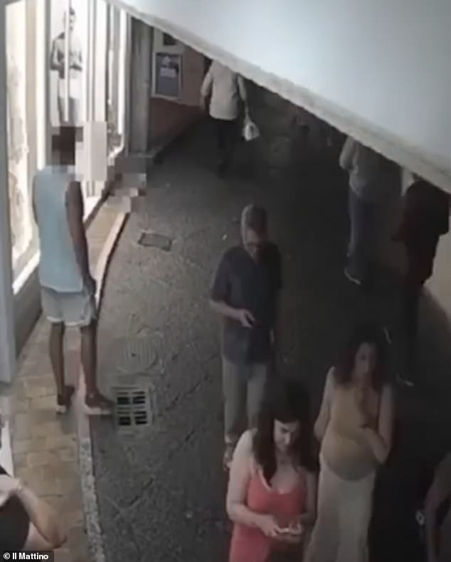 A man in white seen in footage lingering near the politician in Capri on July 16