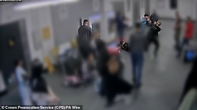Still from CCTV of the altercation at Manchester Airport on July 23 last year showing Muhammad Amaad (centre with back to camera) punching PC Zachary Marsden (obscured) as his brother Mohammed Fahir Amaaz (top right, in light blue) punches PC Ellie Cook