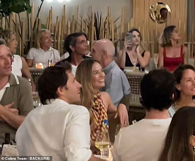 The Aussie actress (pictured centre), who was recently snapped packing on the PDA with her husband Tom Ackerley (pictured opposite her) in Naples, partied the night away on Sunday at a disco-themed dinner on the island of Capri