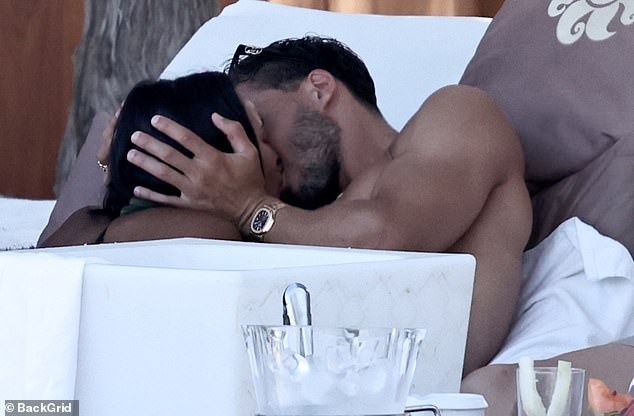 Maya Jama and her boyfriend Ruben Dias shared a steamy kiss as they relaxed at a beach club during their romantic getaway to Ibiza