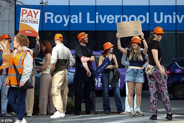 Striking resident doctors hold up placards during a picket outside the Royal Liverpool University Hospital last week