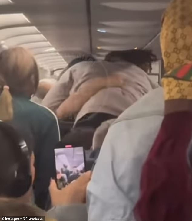 An arrest report states Ishann Sharma approached a fellow passenger and grabbed him without warning by the neck as the man was returning to his seat