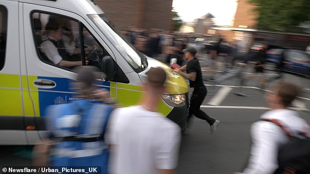 A man was seen being struck by a police van following violent protests outside a migrant hotel in Essex