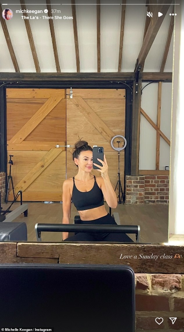 Michelle Keegan displayed her toned figure and impressive abs as she posed in a sports bra during a workout on Sunday - four months after giving birth