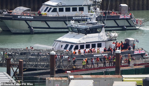 Migrants brought on shore at Dover yesterday after being intercepted by two Border Force cutters
