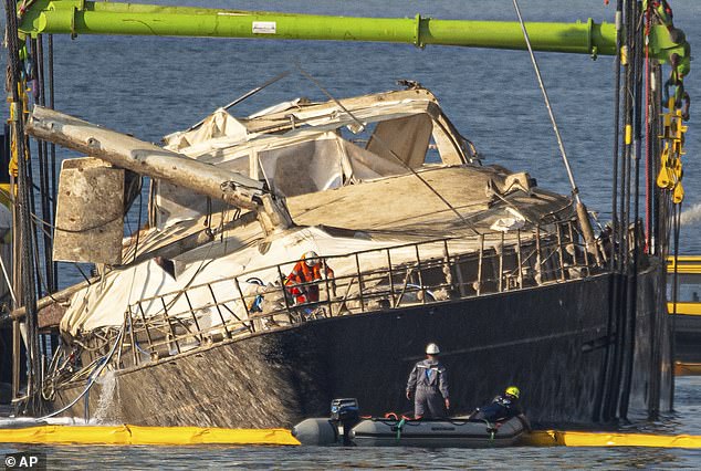 The hull of the superyacht Bayesian, which sank near Palermo, Sicily, on August 19, 2024, is lifted by cranes during salvage operations off the village of Porticello last month