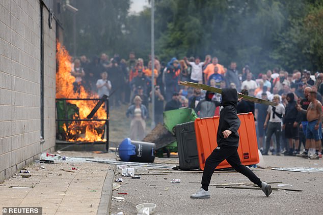A protester throws an object towards the hotel in Rotherham during the riots on August 4, 2024