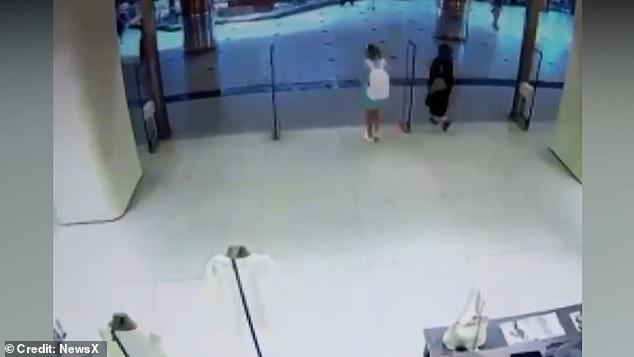 Later footage shows her leaving the store while appearing to be distracted by her phone but with no clothes in hand - and 6,000 lira (£110) of items in her white backpack