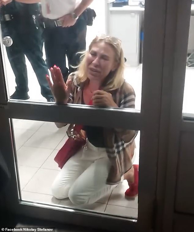 Filmed at Sofia Airport in Bulgaria, the shocking footage (pictured) captures a tearful woman who was brought to her knees in distress as she banged on an airport door while pleading with members of security to allow her onto the aircraft