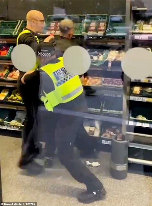 A man suspected of shoplifting was confronted by police who trained a stun gun and CS gas spray on him as they tried to coax him into surrendering