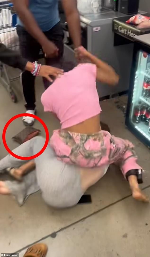 Diamond Tankard (in pink), the grandchild of Ben Tankard and star of Bravo's 'Thicker Than Water' reality show, was taken into custody on Friday after she allegedly assaulted a woman with a sock filled with rocks and stole her Louis Vuitton purse (pictured)