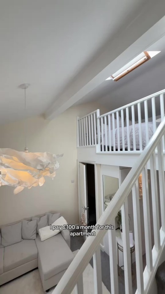 Two-story loft apartment with a bed on the upper level.
