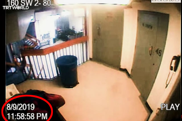 Security camera footage of a hallway.