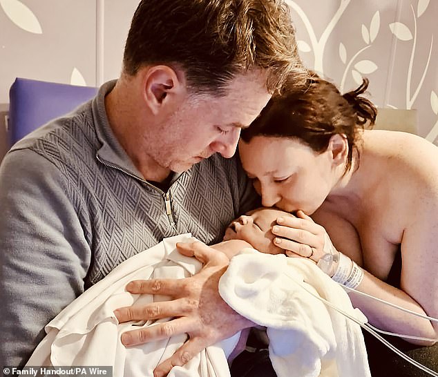 Liliwen Iris Thomas (centre) died after her mother, Emily Brazier (right), was left to give birth alone by midwives and doctors, an inquest told. The father, Rhodri (left), was not present during the birth due to the hospital's strict visiting hours rules