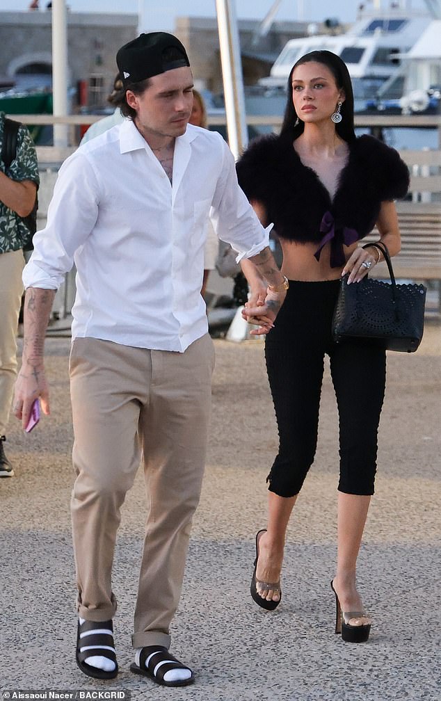 Nicola Peltz appeared strained as she stepped out with husband Brooklyn Beckham in St Tropez on Friday amid their ongoing feud with his famous parents