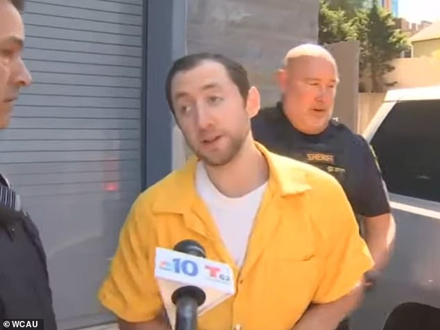 Justin Mohn, 33, (pictured at a previous court appearance) who beheaded his own father and displayed it in a YouTube video last year, erupted into an outrageous rant as he was sentenced to life in prison