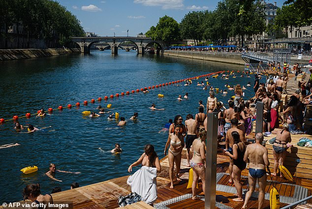 At 8.00am on local time on Saturday, 19 July, dozens of swimmers gathered along the banks of the iconic Parisian river and entered the water as part of the historic reopening (pictured)