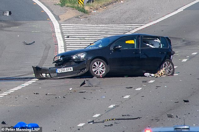 Police have launched a hunt for two women and two men who fled on foot from a Mercedes after a VW Golf driver, 27, was killed in a motorway crash. Pictured: The crashed VW Golf