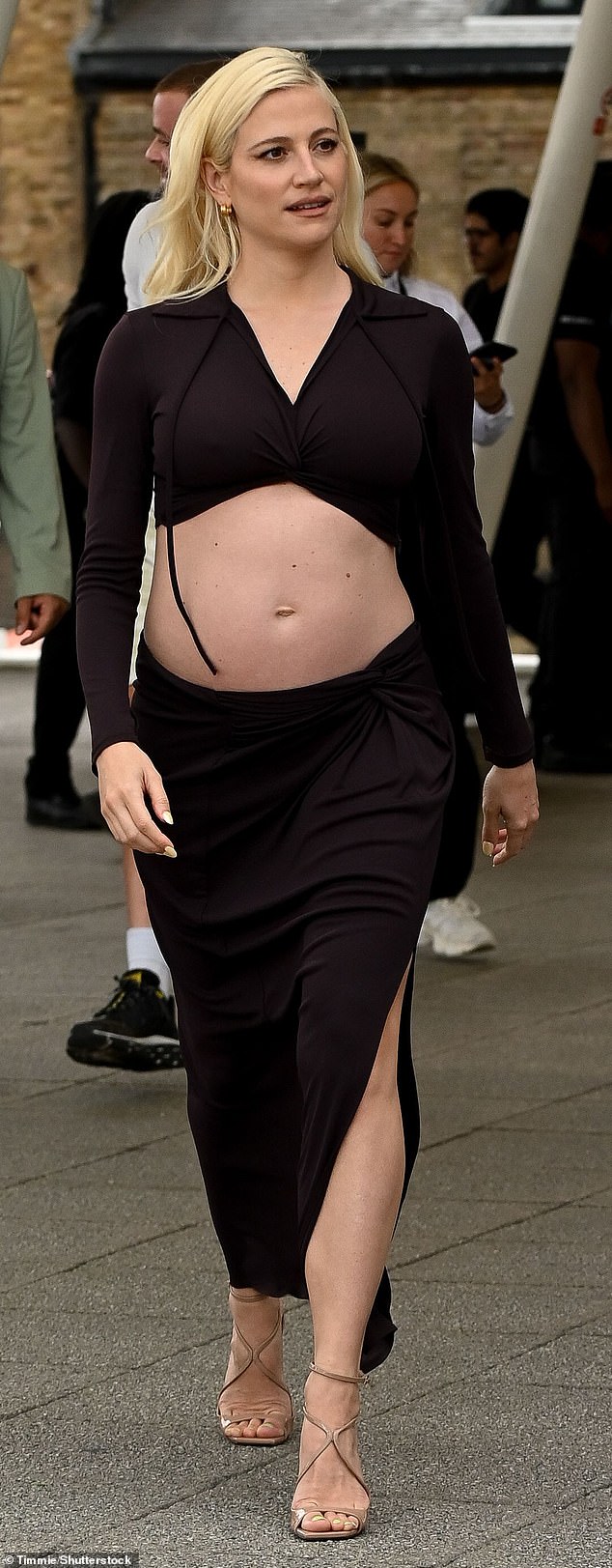 Pixie Lott proudly showcased her baby bump as she arrived at the Excel Centre in London, where she performed at the ABB Formula E FIA World Championships