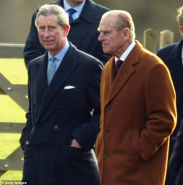 Charles with Philip on Christmas morning in December 2003. Philip allegedly felt Charles lacked the 'dedication necessary to make a good king'