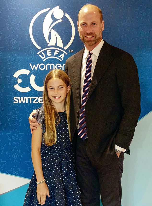 Charlotte has been pictured this afternoon standing close to her father in a sweet blue polka dot dress