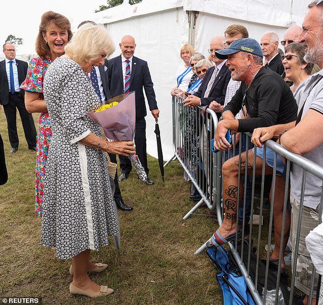 Queen Camilla saw the funny side as she met a royal fan who has had her royal cypher tattooed on his leg