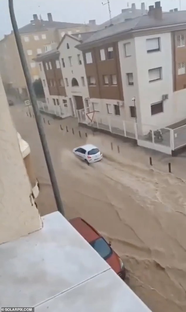 Flood and hail warnings have been issued in Spain as a popular holiday hotspot is deluged - while Britain basks in the sun